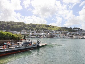 A ferry docked at a harbor with a town in the background. - Ferryside (Dartmouth)