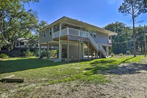 A two-story house with a covered porch and a staircase leading to the upper floor. - Nature Lover's Paradise: Hike, Bike & Fish! (Panacea)