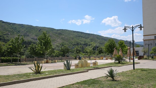 A paved outdoor area with seating and a mountain backdrop. - Beautiful Apartment With Kind And Friendly Owners (tbilisi)