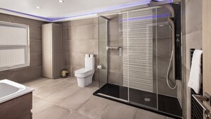 Ein modernes Badezimmer mit Duschkabine, Toilette und Waschbecken.