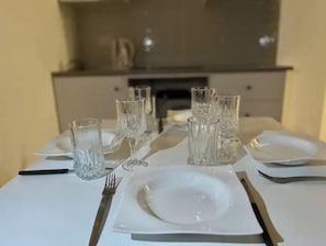 Enjoy meals in style with a beautifully set dining table featuring fine china and crystal glassware.