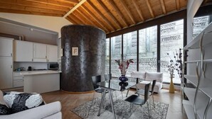 A modern interior with a dining area, kitchen, and seating space. - San Lorenzo (Verona)