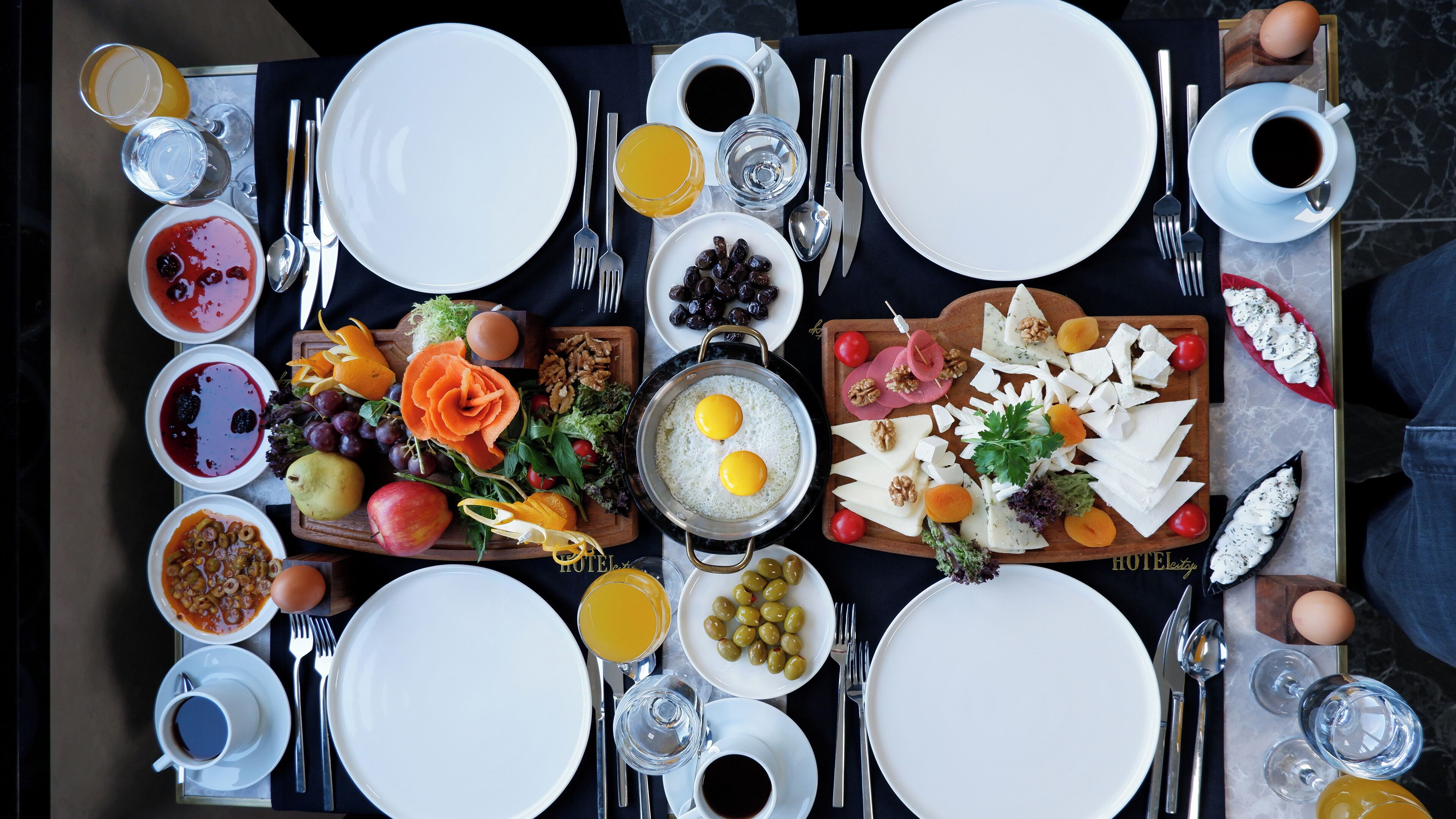 A breakfast buffet with various dishes and beverages.