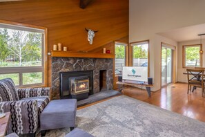 Cozy living area with a fireplace, large window, and comfortable seating.