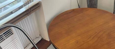 A dining table with a wooden top and metal chairs.