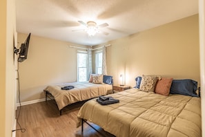 Cozy retreat with a large bed, bedside tables, and a flat-screen TV.