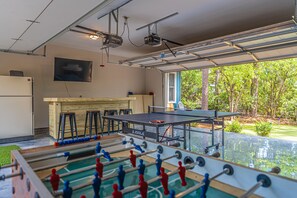 Relax and play in this spacious indoor recreation area featuring a foosball table and ping pong table.