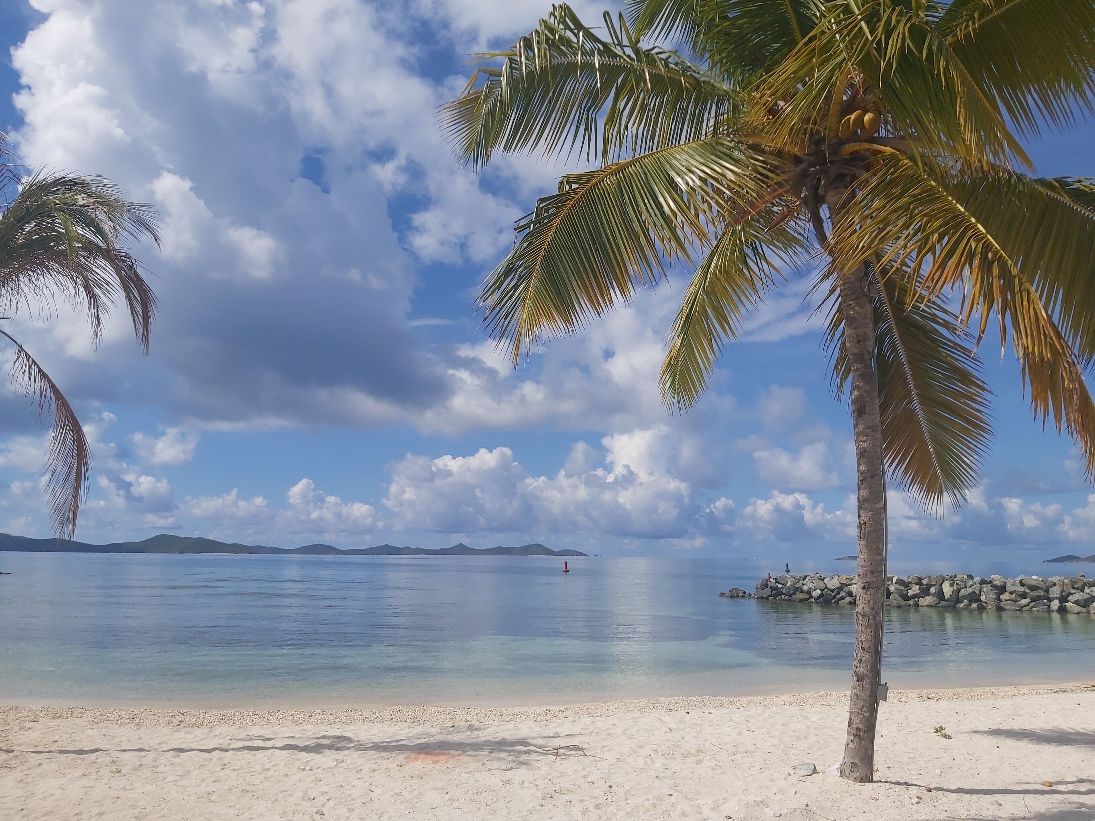 On the beach, white sand, sun-loungers, beach umbrellas