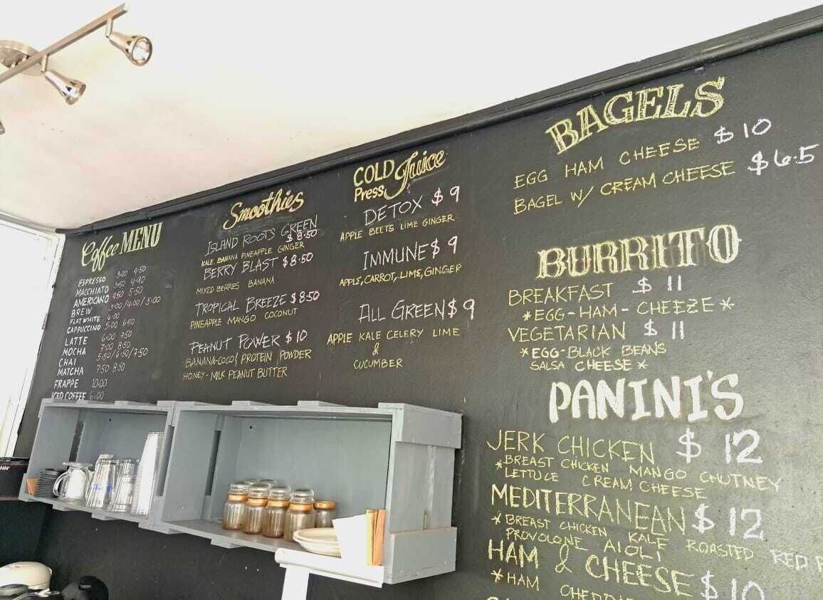 A chalkboard menu with various food and drink options.