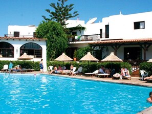 Outdoor pool, a heated pool, pool umbrellas, sun loungers