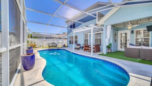 A swimming pool with a covered patio area, outdoor seating, and a view of the surrounding landscape. - Welcome to Alena's Place! Only minutes away from Disney! (Kissimmee)