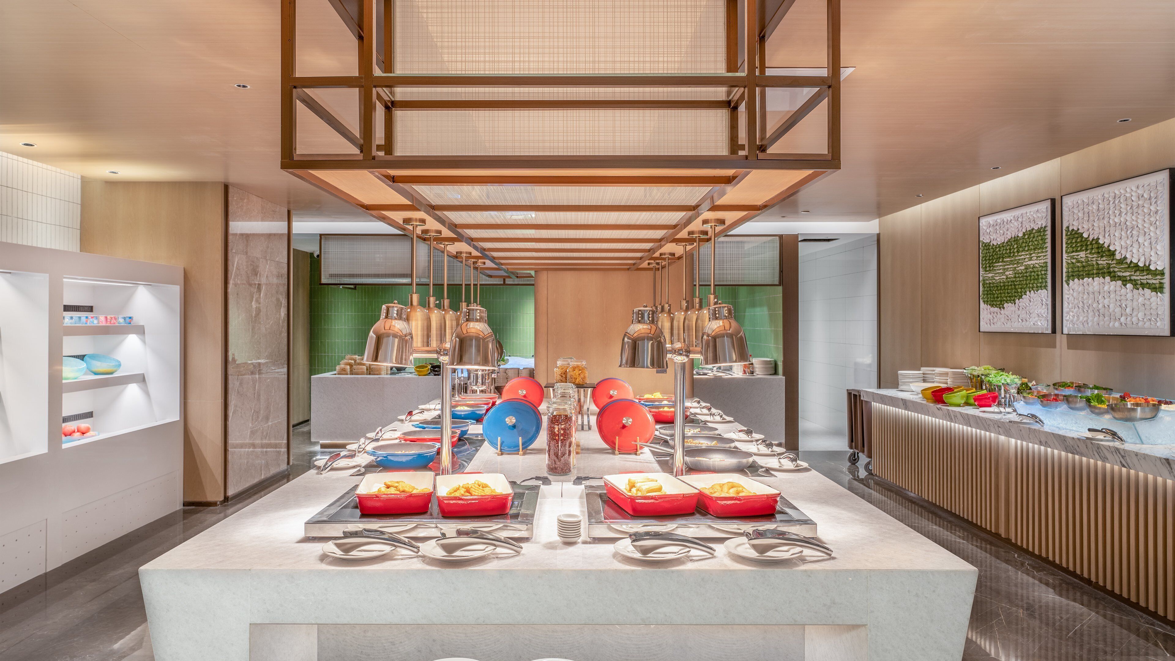 A buffet setup with various food items and serving utensils.