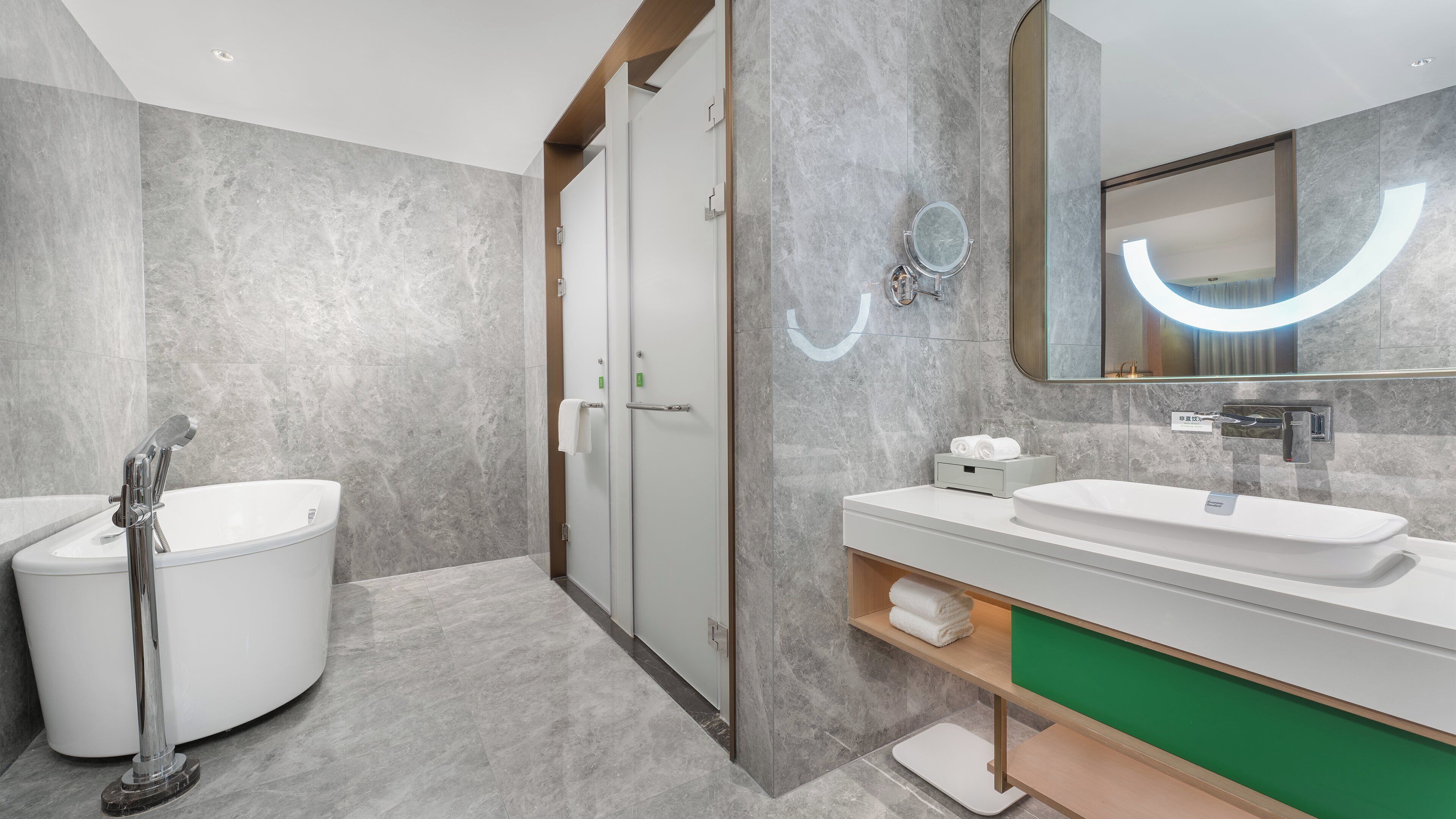 A modern bathroom with a bathtub, a sink, and a shower.