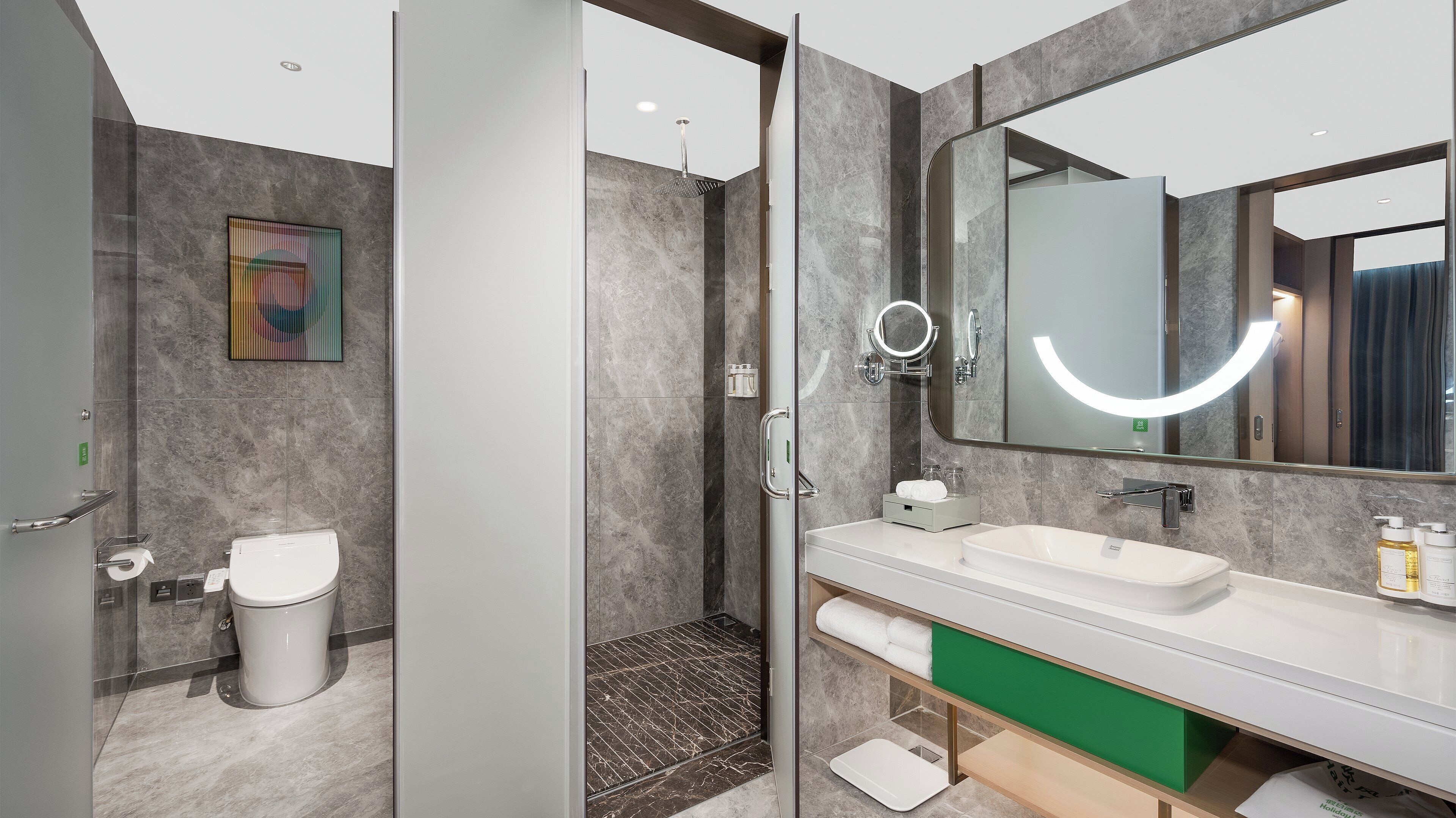 A modern bathroom with a glass-enclosed shower, a large mirror, and a white sink.
