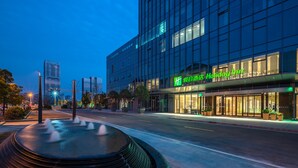 A modern hotel building with a prominent 'Holiday Inn' sign, large windows, and a well-lit entrance area. - Holiday Inn Changsha Malanshan by IHG (Changsha)