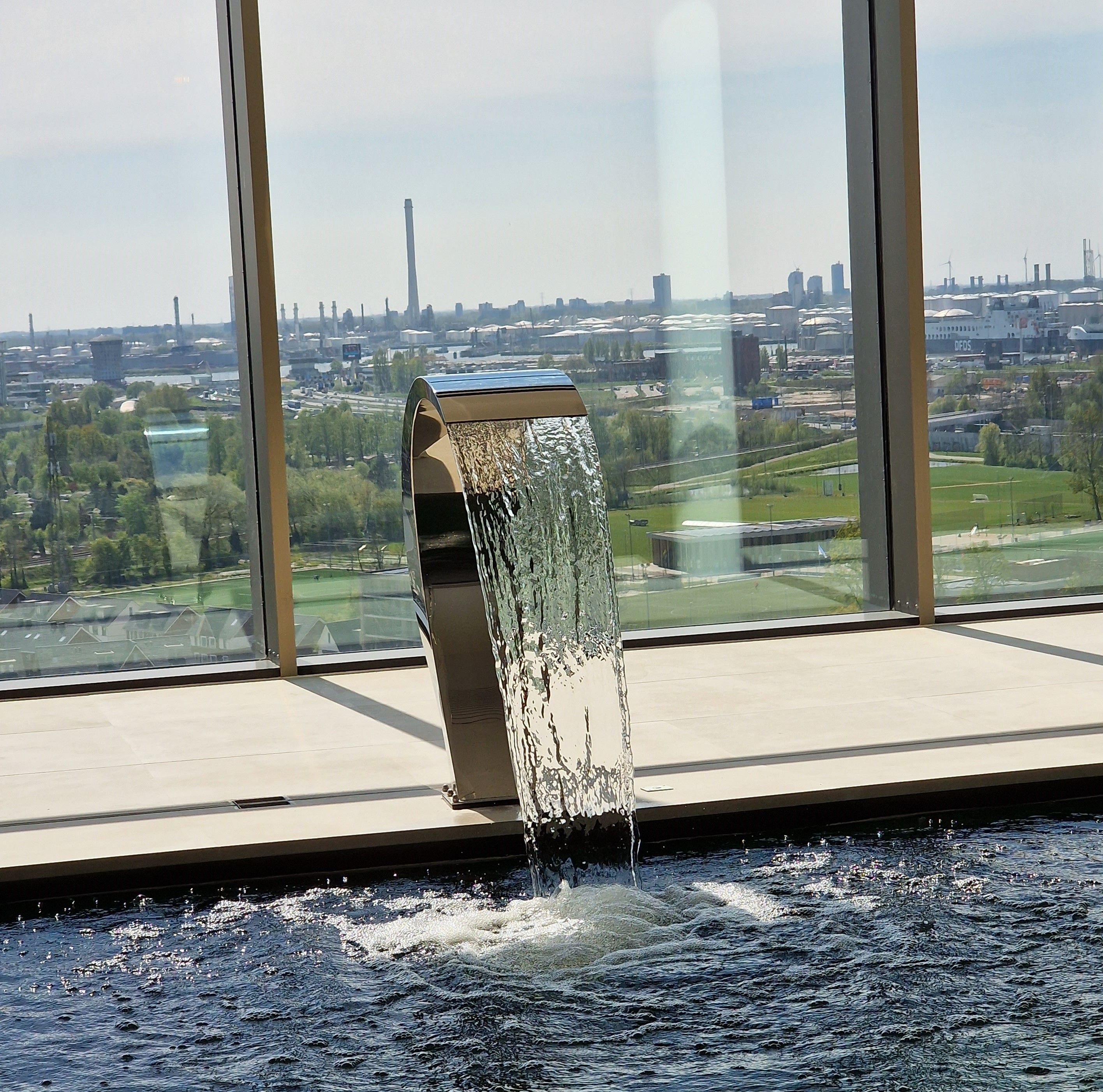 A modern building with a large window overlooking a cityscape.