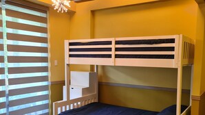 A bunk bed with a mattress and pillows, a ceiling fan, and a window with blinds. - PICO DE LORO ROOM FOR RENT by BILLYN HAMILO COAST, BATANGAS (Nasugbu)