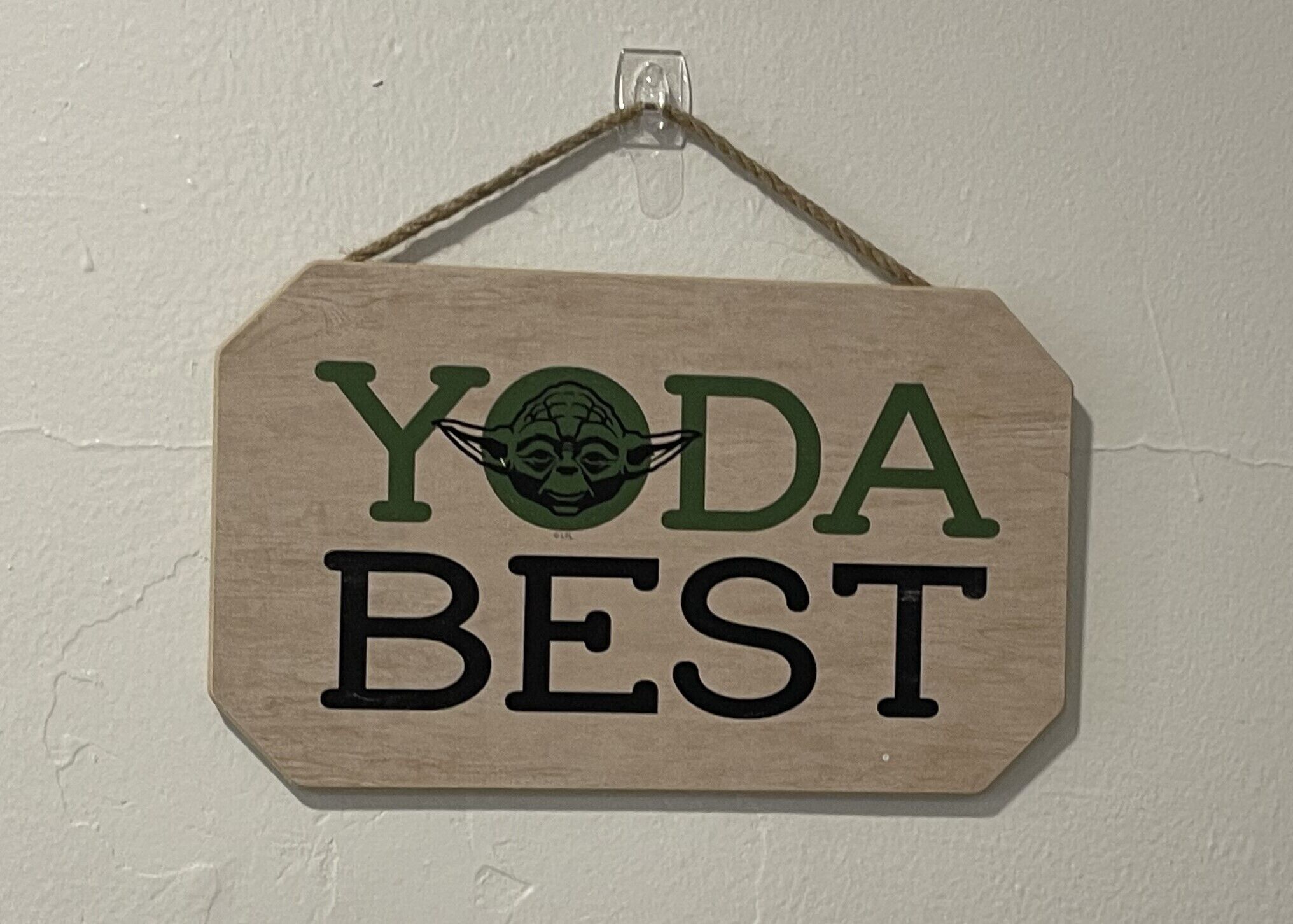 A wooden sign with the text "YODA BEST" and a Yoda graphic.
