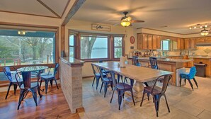 A spacious kitchen with a large island, wooden cabinets, and a view of the outdoors. - Roomy Texas Lake Retreat w/ Private Boat Ramp (Frankston)