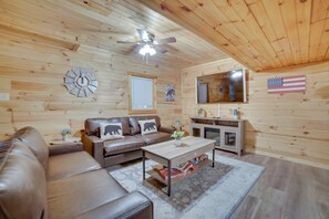Cozy living room with a comfortable couch, wooden coffee table, and television on a wooden stand.