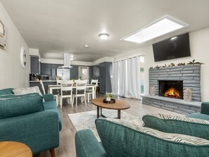 Cozy living space with a central dining area, seating area, and fireplace.