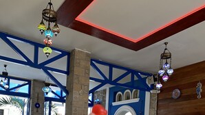 A dessert on a table with a blue and white interior, including a stone pillar and a wooden ceiling.