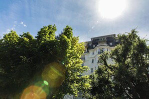A multi-story building with a classic architectural style, surrounded by lush green trees. - Majestic 145 Historical Building Chamonix All Year (Chamonix)