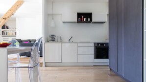 A modern kitchen with white cabinets, a built-in oven, and a black countertop. - Le Majestic 145 appt -  sleeps 6 guests in 3 bedrooms, centre Chamonix, parking (Chamonix)