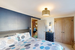 Cozy retreat with a comfortable bed, wardrobe, and dresser.