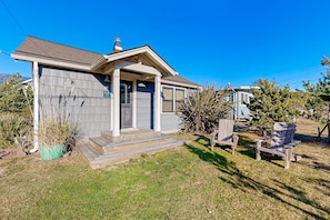 Relax on the front porch with a view of the well-maintained lawn and lush surroundings.