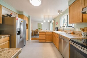 Enjoy cooking in the well-equipped kitchen with a central island and dining area nearby.