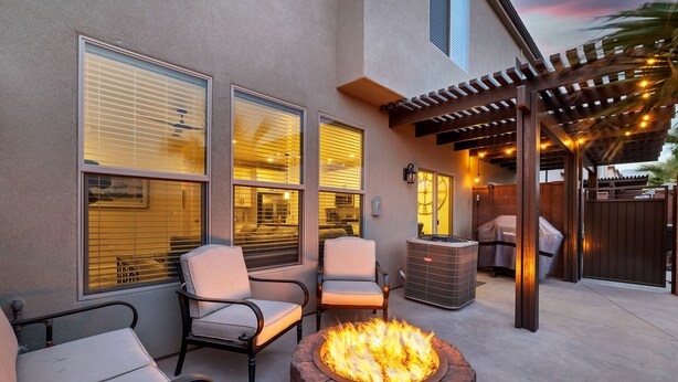 A patio area with a fire pit, outdoor seating, and a pergola. - New Townhouse St George area, VidaSol (Washington)
