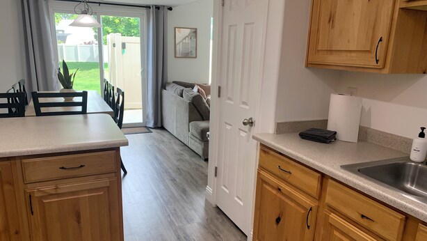 A kitchen with wooden cabinets, a countertop, and a sink. - Cozy Townhome Gathering Spot (Clinton)