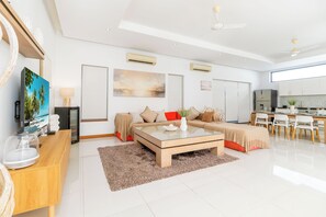 A modern living room with a sofa, coffee table, and a painting.