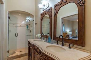 A bathroom with two sinks, a large mirror, and a shower enclosure. - 8 Suites Near Monterey& Carmel (Salinas)