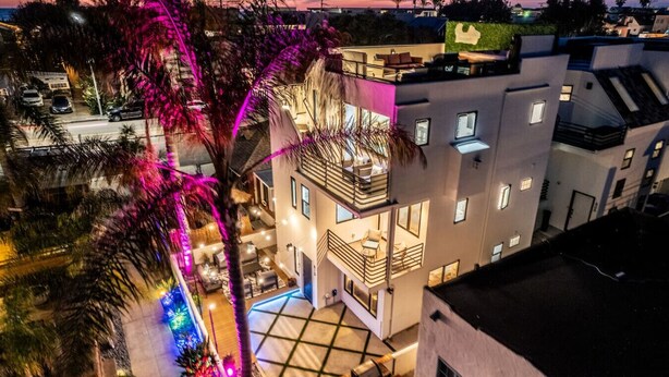 A modern multi-story building with a rooftop pool, balconies, and a view of the surrounding area. - Ocean & Bay Views w/ Private Rooftop Hot Tub (San Diego)