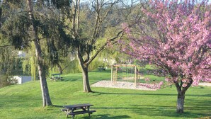 A park with picnic tables, a gazebo, and blooming trees. - Character house in a romantic setting "At the water's'edge (CHAMBON SUR VOUEIZE)