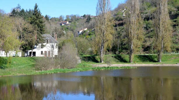 A serene lakeside view with a white building, trees, and a clear sky. - Character house in a romantic setting "At the water's'edge (CHAMBON SUR VOUEIZE)