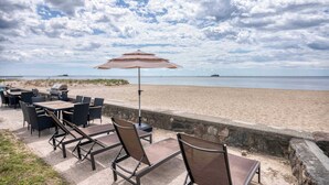 Outdoor seating with a view of the beach and ocean. - Duckling Crossing | Beach House on the Sand (Westbrook)