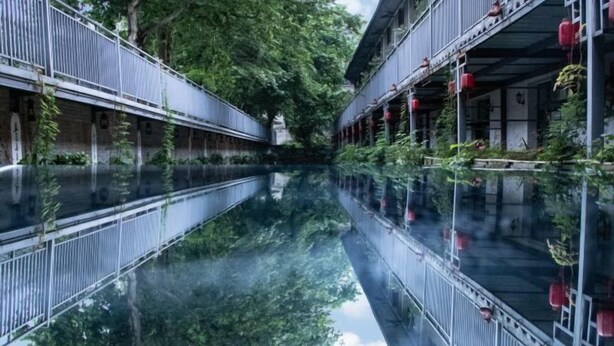 A serene hotel corridor with a reflective waterway, traditional architecture, and red lanterns. - Mugen Town Residence (Zixing)