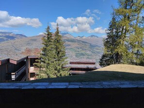 A building with a view of mountains and trees.