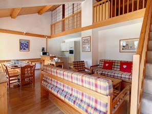 A multi-level living space with wooden floors, a dining area, a kitchen, and a loft bedroom. - Spacious Duplex 8 pers · Ski-in/Ski-out · Balcony (Saint-Martin-de-Belleville)