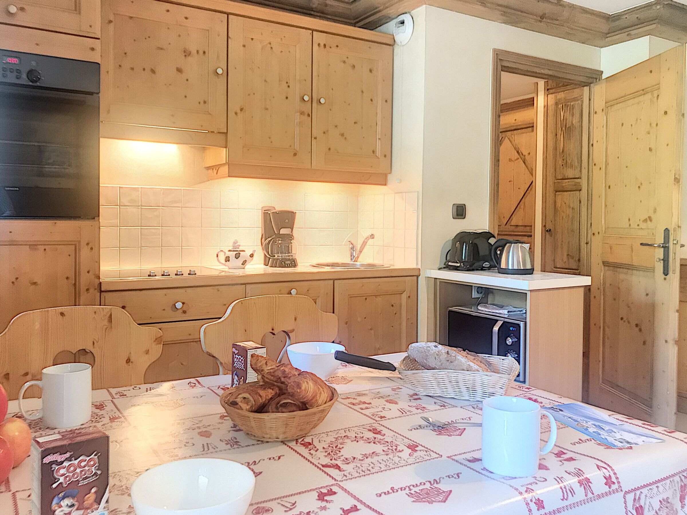 A kitchen with wooden cabinets, a coffee maker, and a toaster on the counter.