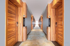 A hallway with wooden paneling on the walls and a patterned carpet. - Nanning Unitour Hotel (Nanning)