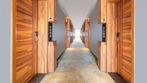 A hallway with wooden paneling and a patterned carpet. - Nanning Unitour Hotel (Nanning)