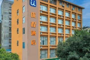 A multi-story hotel building with a prominent sign indicating it is a hotel. - Nanning Unitour Hotel (Nanning)
