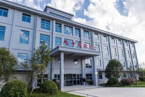 A multi-story building with a prominent entrance and signage. - Tianzihu Boutique Hotel (Anji)