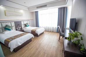 A hotel room with two beds, a desk, a chair, and a television. - Tianzihu Boutique Hotel (Anji)