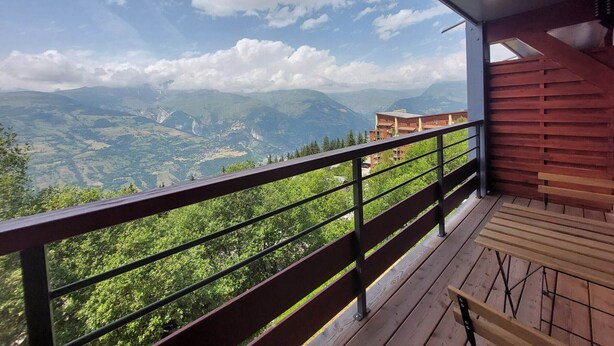 Un balcón con vistas a un paisaje montañoso.