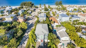 An aerial view of a coastal residential area with houses, roads, and a beach. - Seahorse Dreams by Beach Boutique Rentals (Bradenton Beach)